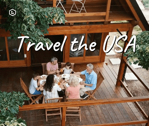 Family enjoying a getaway adventure vacations meal together on a wooden deck surrounded by greenery.